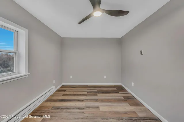 a view of room with window and ceiling fan