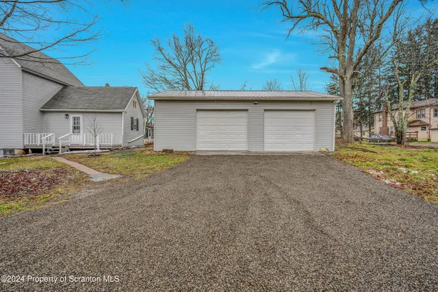 a house that has a tree in front of it