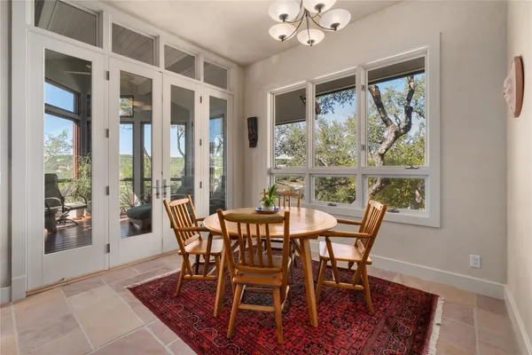 a view of a dining room with furniture wooden floor and a chandelier