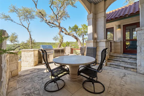 a view of a chairs and table in backyard