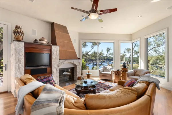 a living room with fireplace furniture and a large window
