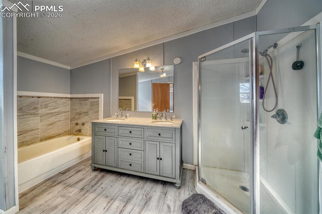 36 Valley Circle Guffey, CO 80820 - Photo 12 of 29 a bathroom with a tub shower vanity and a sink
