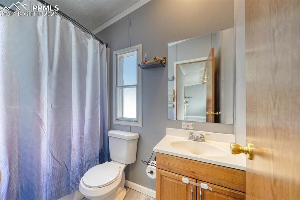 36 Valley Circle Guffey, CO 80820 - Photo 13 of 29 a bathroom with a sink a toilet a mirror and shower