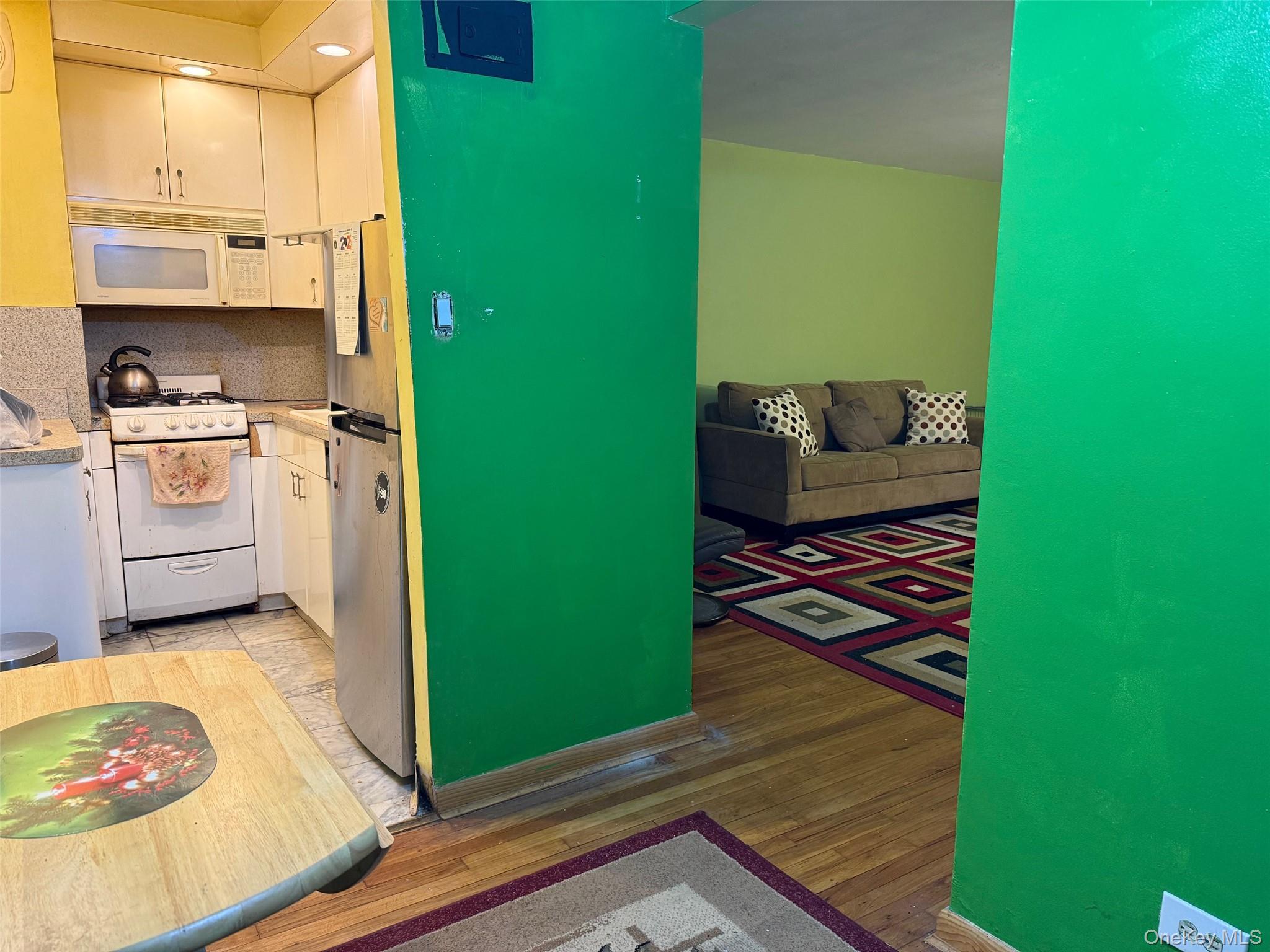 83-25 98th Street, Unit 3B Queens, NY 11421 - Photo 5 of 8 a kitchen with a refrigerator and a stove