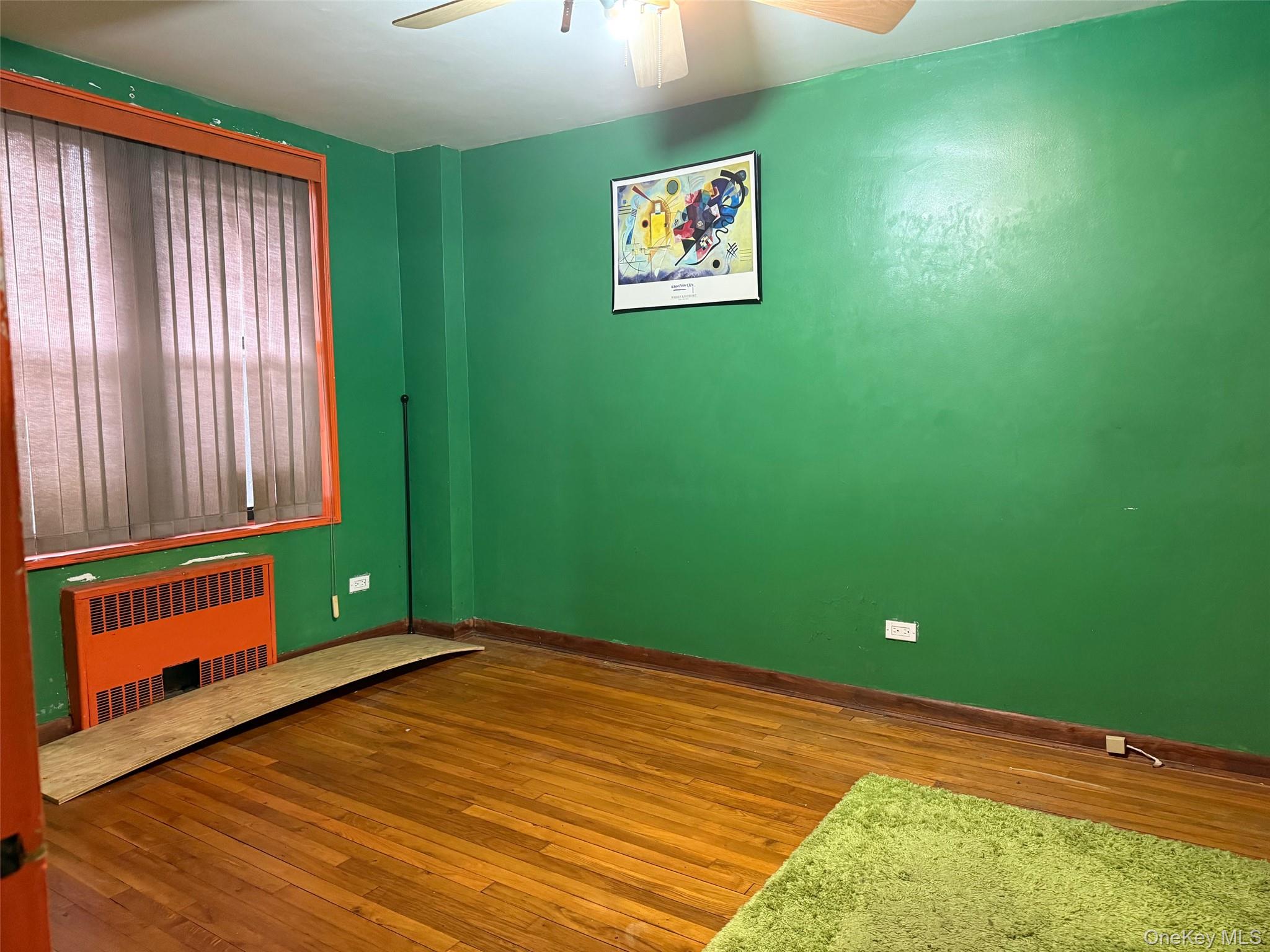 83-25 98th Street, Unit 3B Queens, NY 11421 - Photo 6 of 8 a view of a room with a fan and window