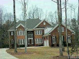 9401 Shadow Oak Way Raleigh, NC 27615 - Photo 1 of 1 a front view of a house with a garden