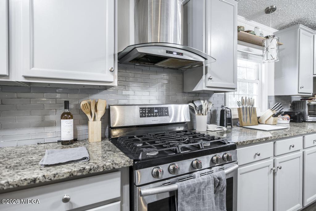 319 Pope Road Roberta, GA 31078 - Photo 12 of 42 a kitchen with granite countertop a stove and a sink