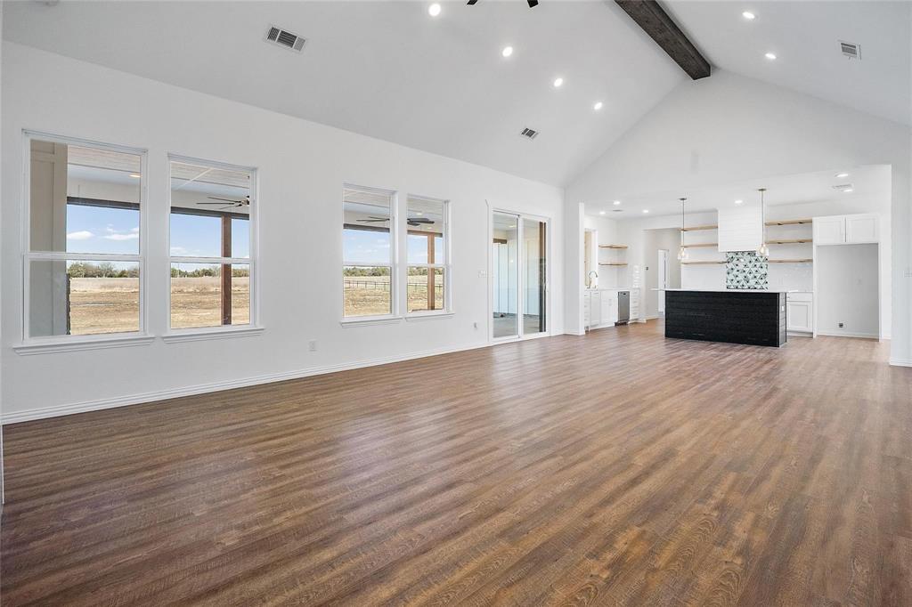 3093 Willow Road Celeste, TX 75423 - Photo 14 of 40 an empty room with wooden floor and windows