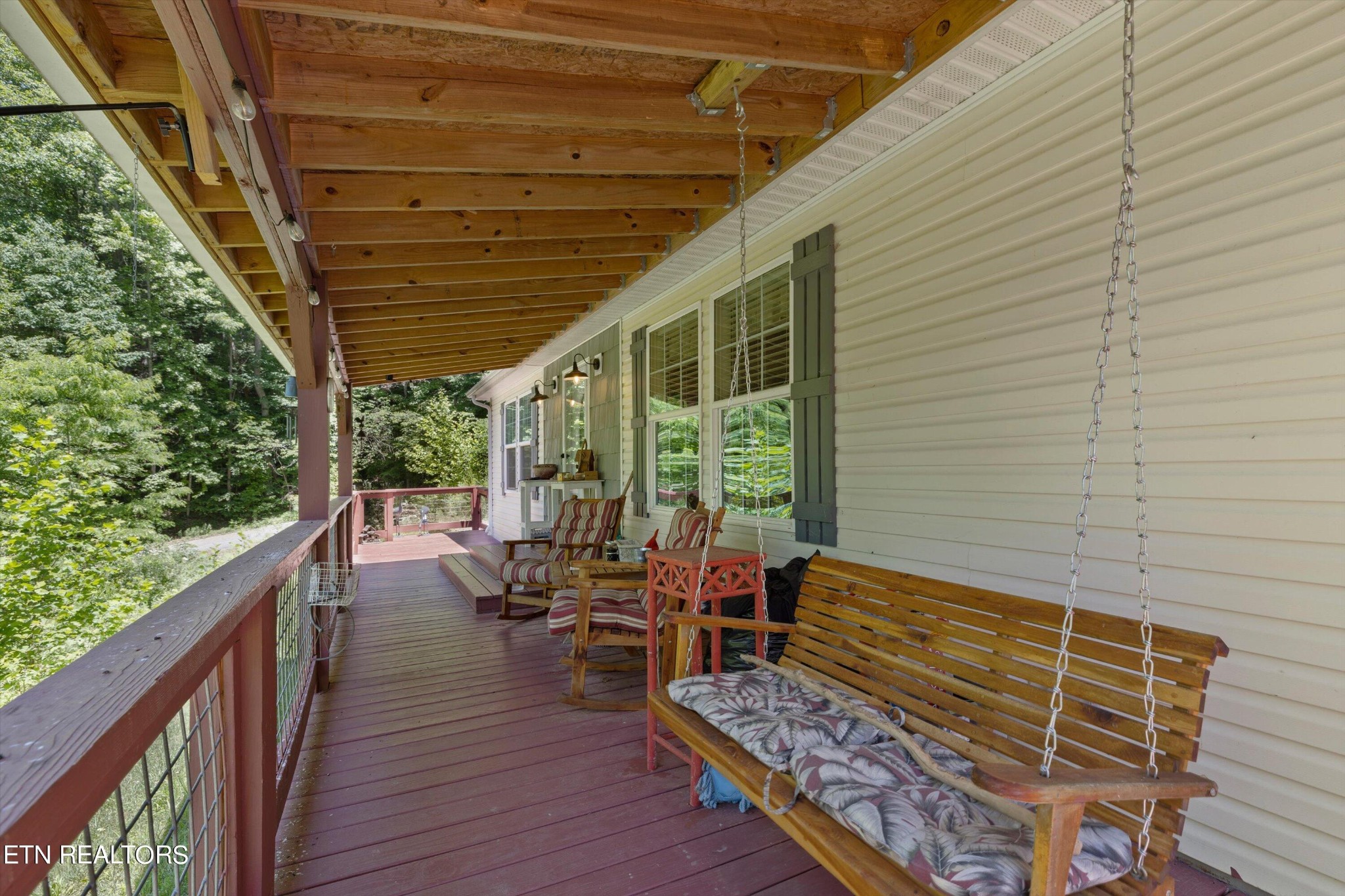 180 Greasy Cove Road Cosby, TN 37722 - Photo 5 of 28 a balcony with chairs and wooden floor