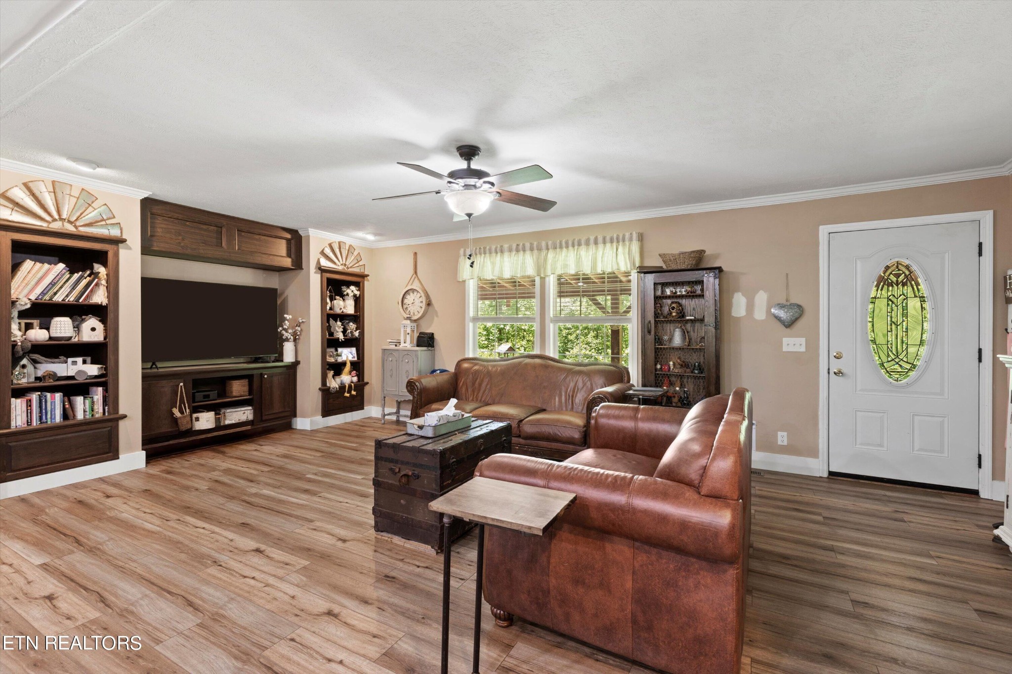 180 Greasy Cove Road Cosby, TN 37722 - Photo 8 of 28 a living room with furniture a bookshelf and a flat screen tv