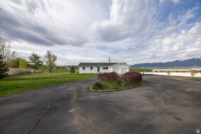4155 Johnson Road Nibley, UT 84321 - Photo 52 of 71 Ranch-style home featuring a garage, a mountain view, and asphalt driveway