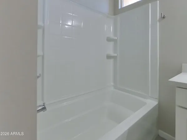 a bathroom with a bathtub a sink and a mirror