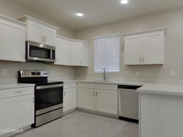 a view of a kitchen with electric appliances