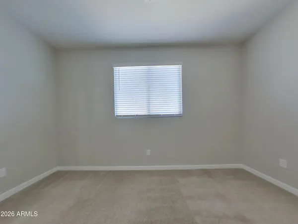 a kitchen with stainless steel appliances granite countertop white cabinets a sink a stove a microwave and wooden cabinets