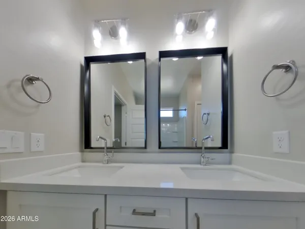 a bathroom with a shower sink and mirror