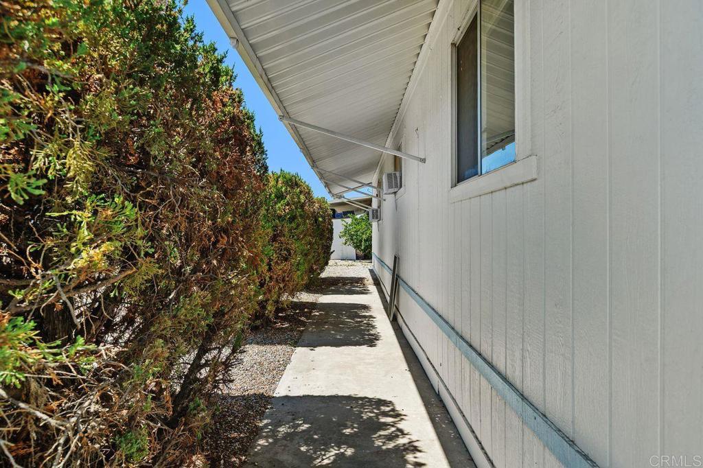 530 West Devonshire Avenue, Unit 84 Hemet, CA 92543 - Photo 35 of 36 a view of a pathway of a house with wooden stairs