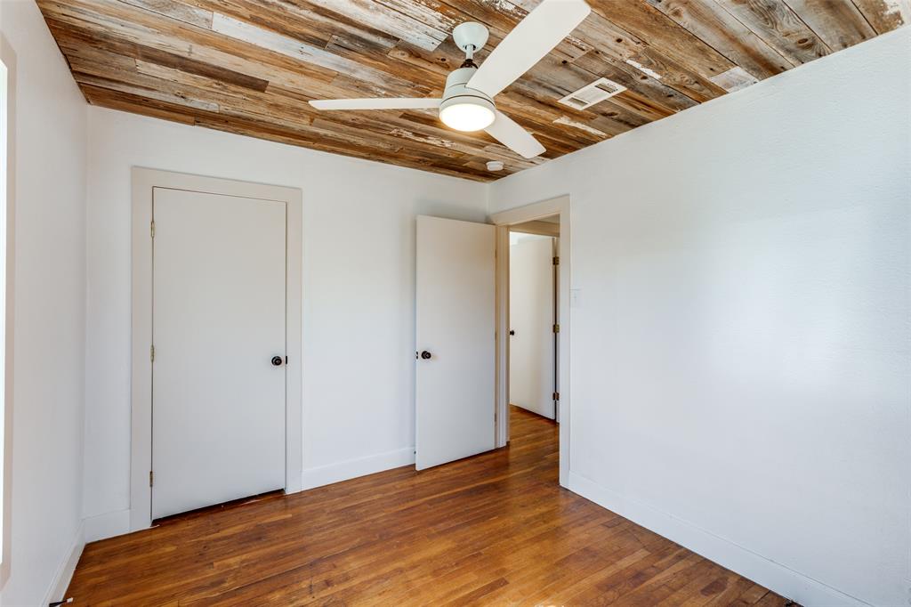 2012 Payne Avenue, Unit A Austin, TX 78757 - Photo 25 of 33 Room featuring a reclaimed wood ceiling, wood flooring, white painted walls, and a ceiling fan with integrated lighting