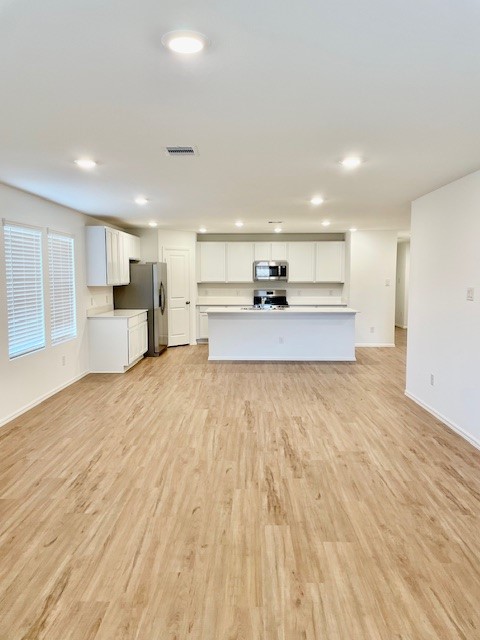 18646 Gravago Lane New Caney, TX 77357 - Photo 13 of 21 a large kitchen with stainless steel appliances kitchen island a large counter top and a wooden floors