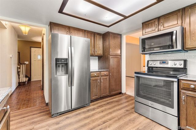 a kitchen with a refrigerator stove and microwave