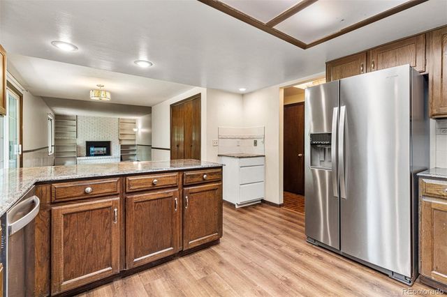 a kitchen with stainless steel appliances a refrigerator and wooden cabinets