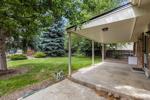 a view of a house with backyard and porch