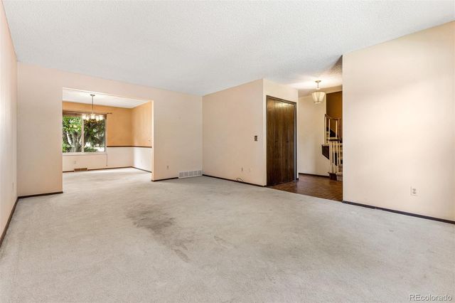 an empty room with a empty space and windows