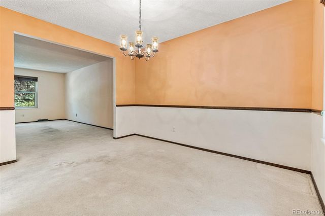 a view of a livingroom with a ceiling fan and entryway