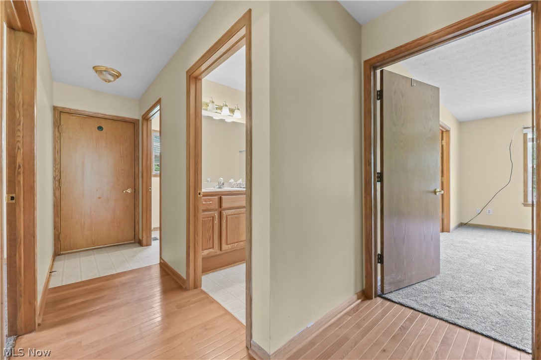 1701 Woods Road Akron, OH 44306 - Photo 21 of 43 Hallway to garage. Primary bedrm off to the right.