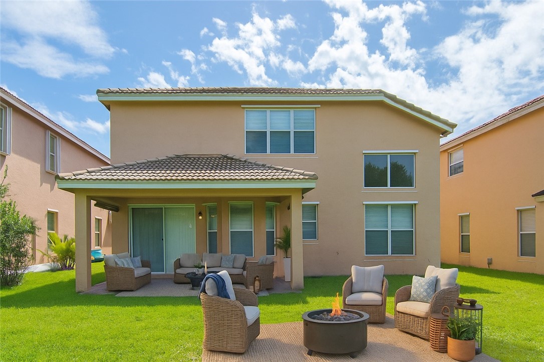 1923 Grey Falcon Circle Southwest Vero Beach, FL 32962 - Photo 23 of 36 a view of a house with backyard sitting area and garden