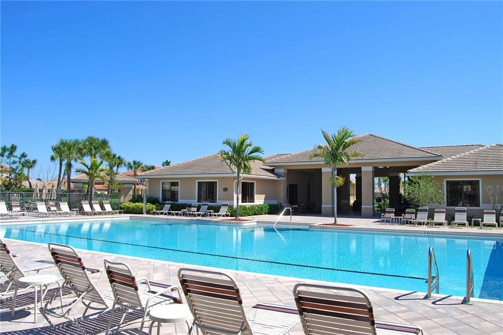 1923 Grey Falcon Circle Southwest Vero Beach, FL 32962 - Photo 29 of 36 a swimming pool view with a seating space and a garden view