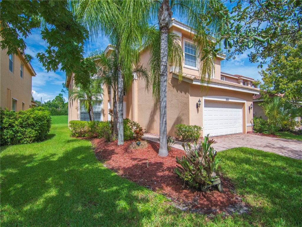 1923 Grey Falcon Circle Southwest Vero Beach, FL 32962 - Photo 3 of 36 front view of a house with a small yard