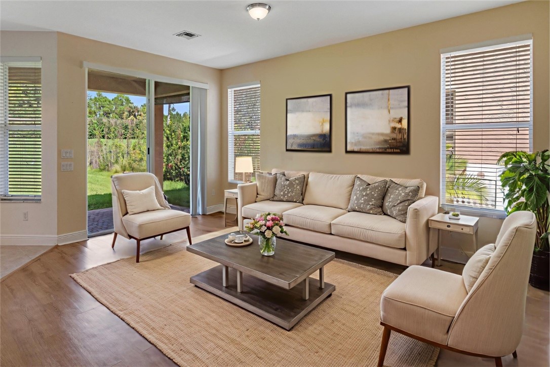 1923 Grey Falcon Circle Southwest Vero Beach, FL 32962 - Photo 10 of 36 a living room with furniture and a large window