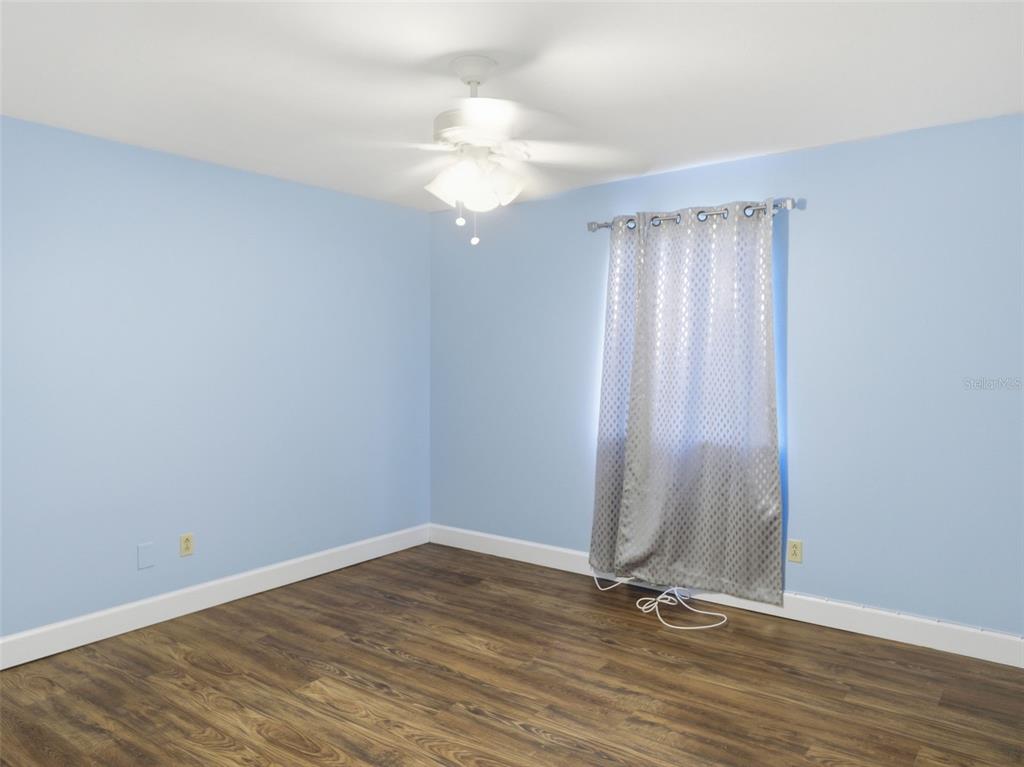 6519 West Newberry Road, Unit 1006 Gainesville, FL 32605 - Photo 14 of 31 a view of a room with wooden floor and white walls
