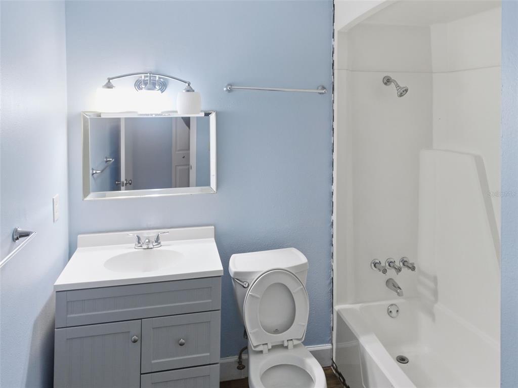 6519 West Newberry Road, Unit 1006 Gainesville, FL 32605 - Photo 19 of 31 a bathroom with a toilet sink and mirror