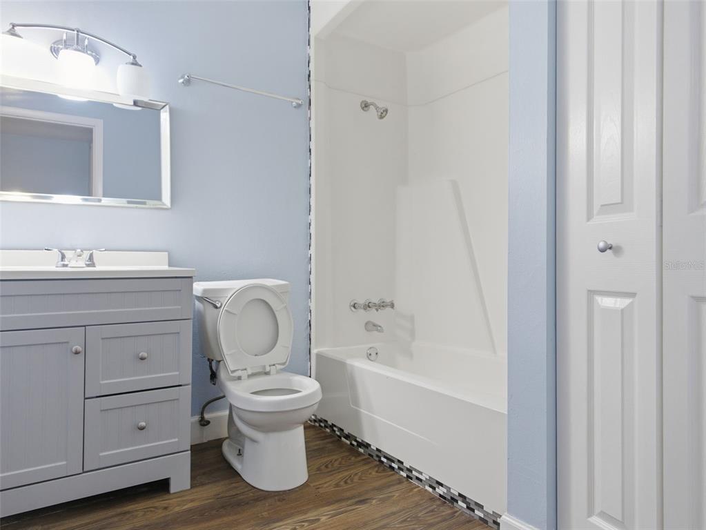 6519 West Newberry Road, Unit 1006 Gainesville, FL 32605 - Photo 21 of 31 a bathroom with a toilet sink and mirror
