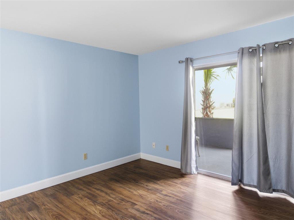 6519 West Newberry Road, Unit 1006 Gainesville, FL 32605 - Photo 5 of 31 an empty room with wooden floor and door