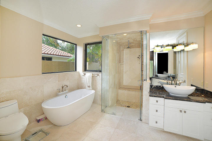 5686 St Annes Way Boca Raton, FL 33496 - Photo 11 of 18 a spacious bathroom with a granite countertop sink and a mirror a bathtub