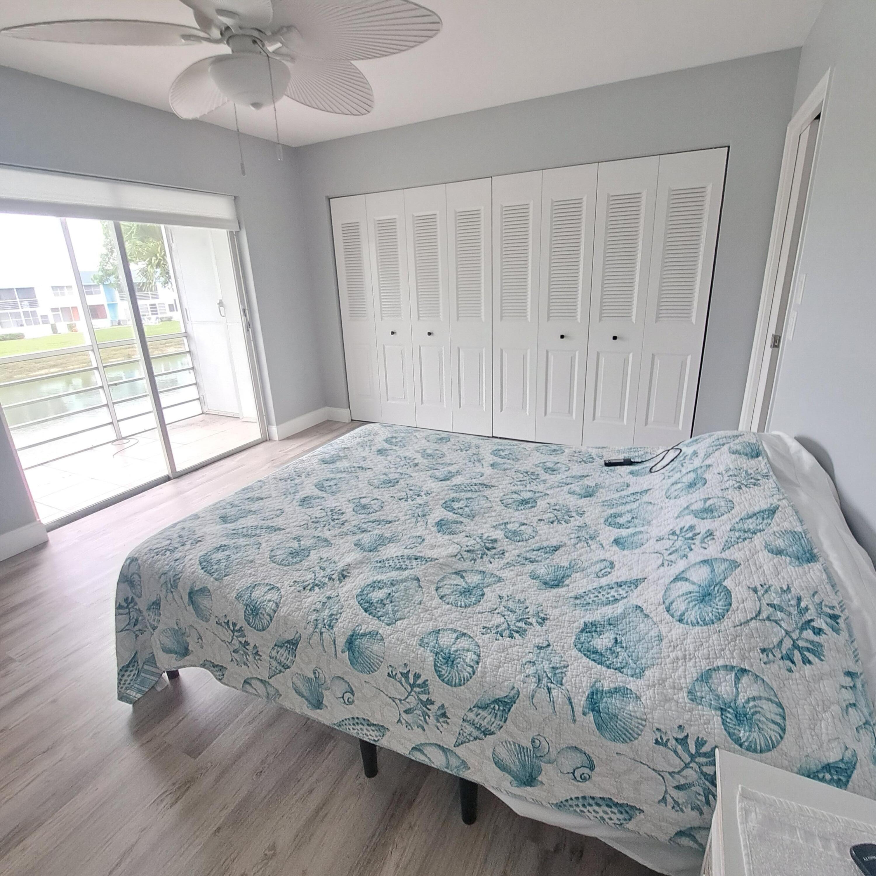 55 Northampton C West Palm Beach, FL 33417 - Photo 11 of 14 a large bed sitting in a bedroom next to a window