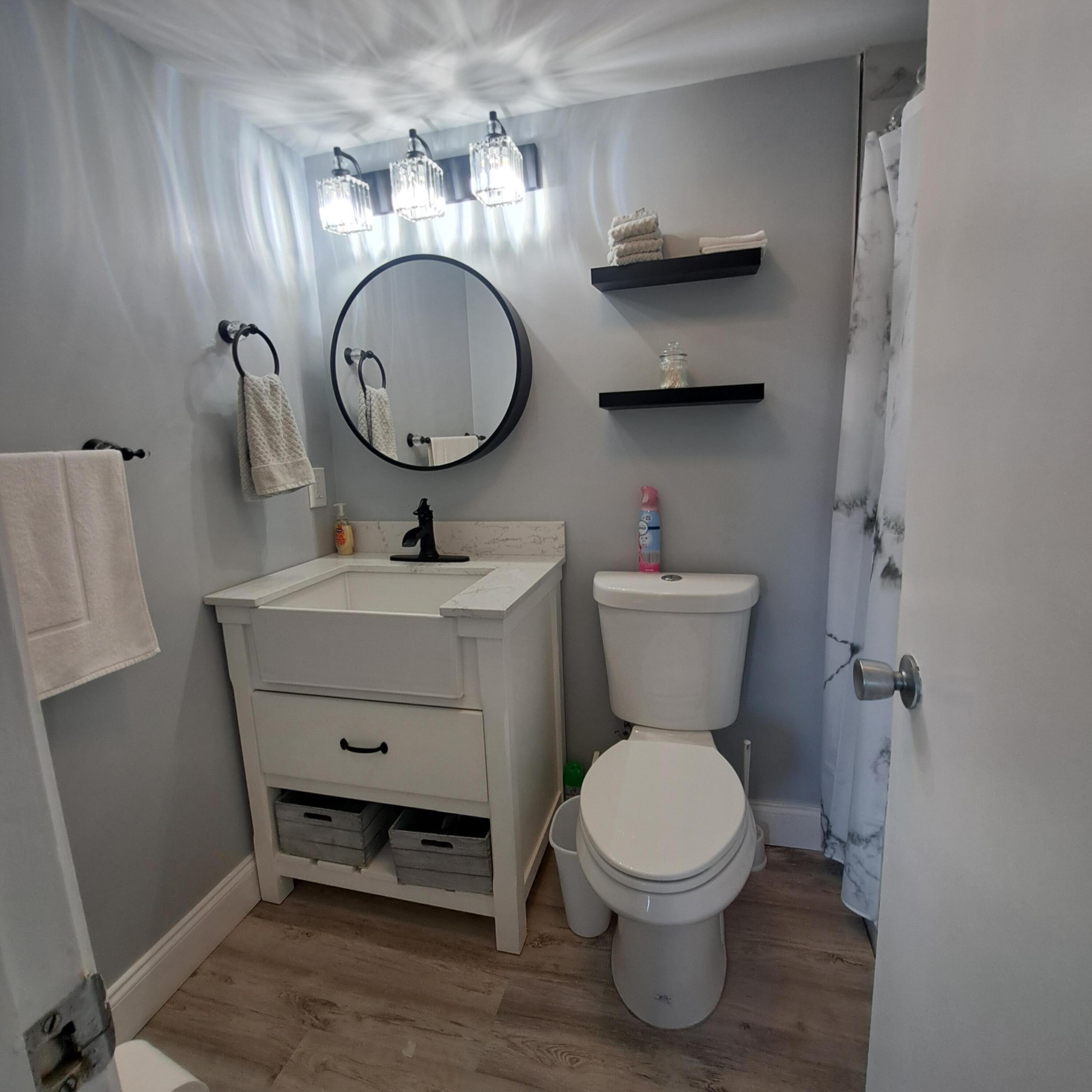 55 Northampton C West Palm Beach, FL 33417 - Photo 12 of 14 a bathroom with a toilet a sink and a mirror