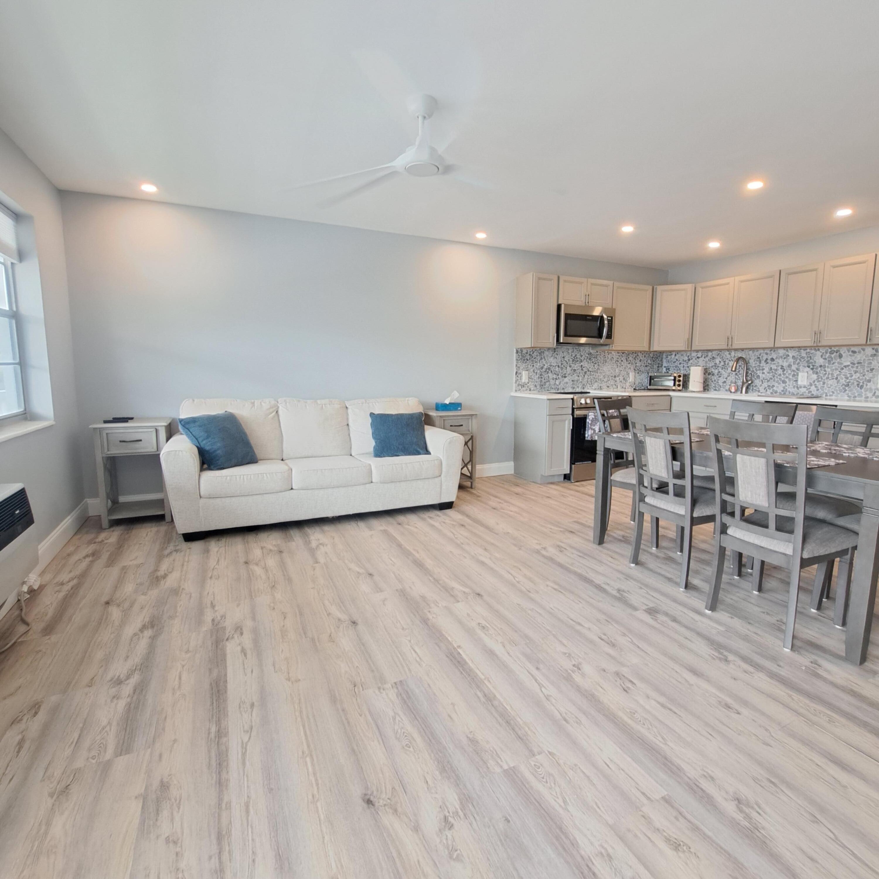 a living room with lots of furniture and kitchen view