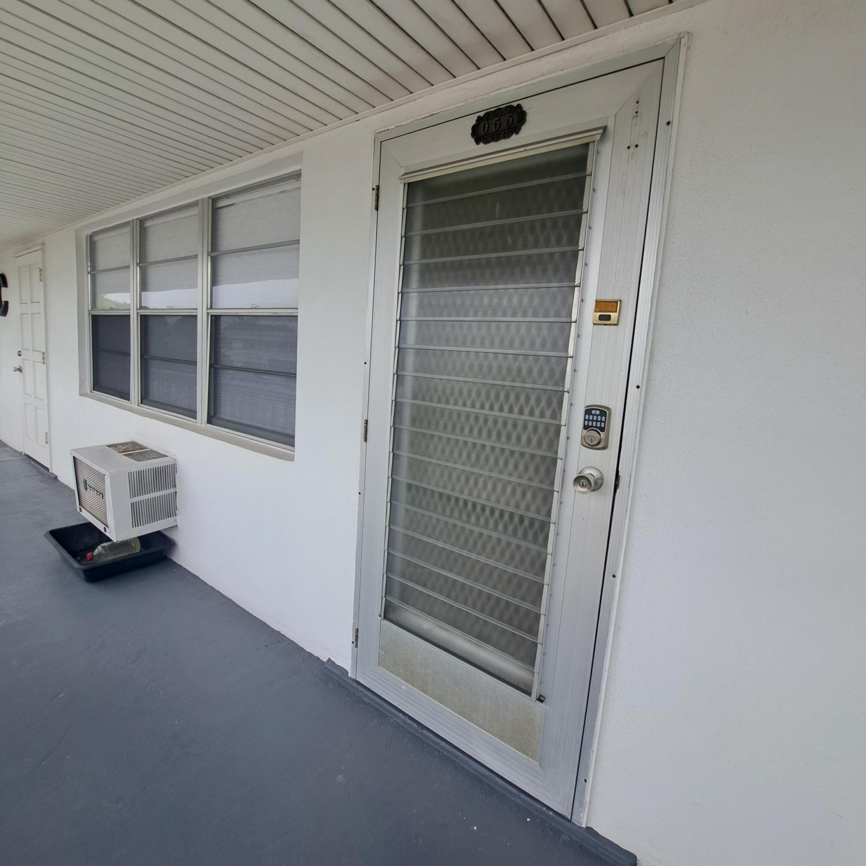 55 Northampton C West Palm Beach, FL 33417 - Photo 2 of 14 a view of an empty room with a window