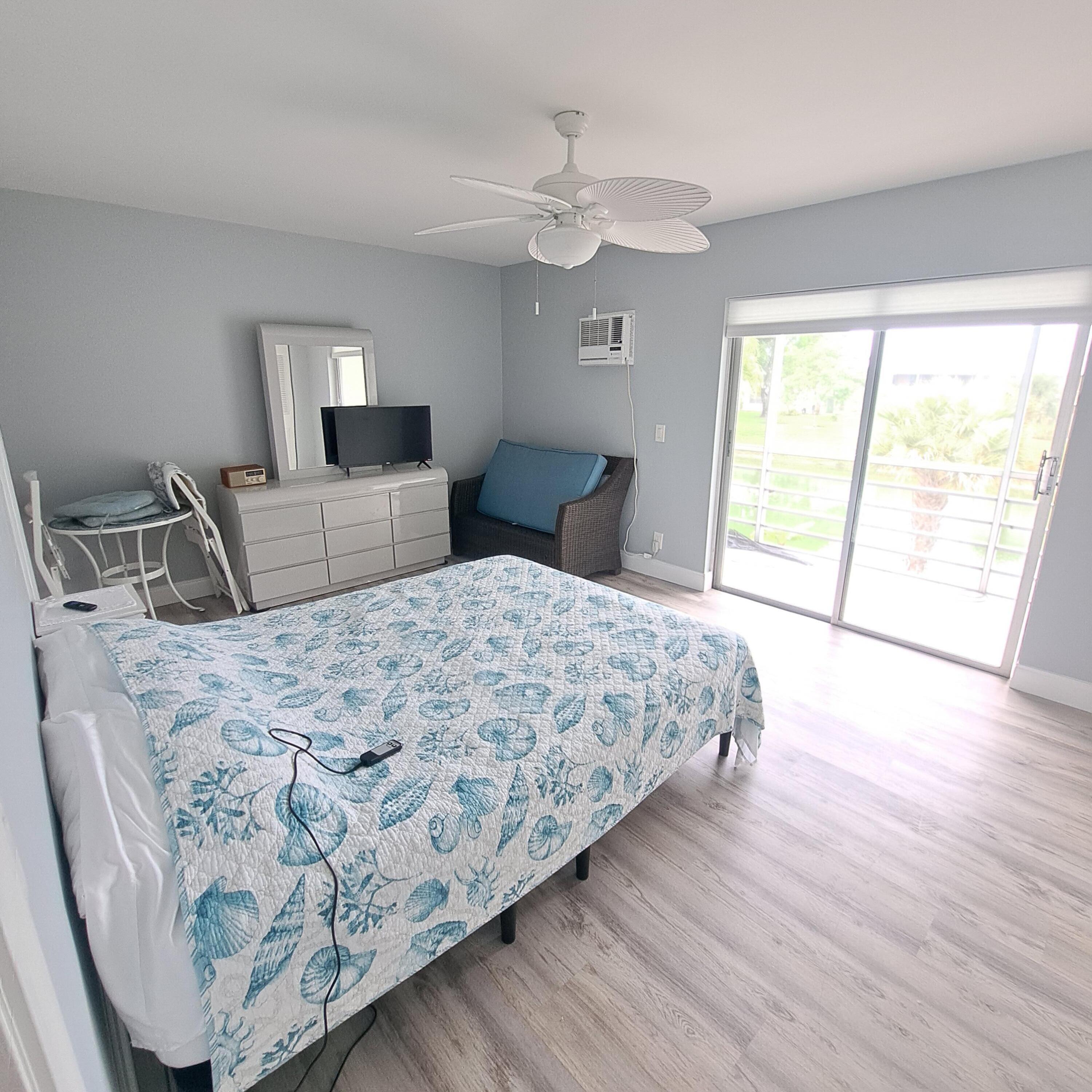 55 Northampton C West Palm Beach, FL 33417 - Photo 9 of 14 a bedroom with a large bed and a window