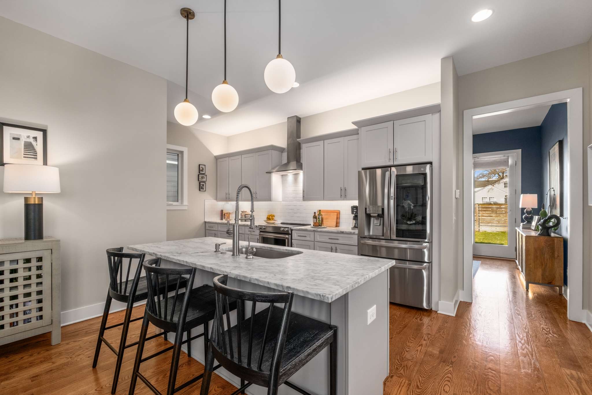 115 Rains Avenue, Unit A Nashville, TN 37203 - Photo 11 of 46 a kitchen with a table chairs and wooden floor