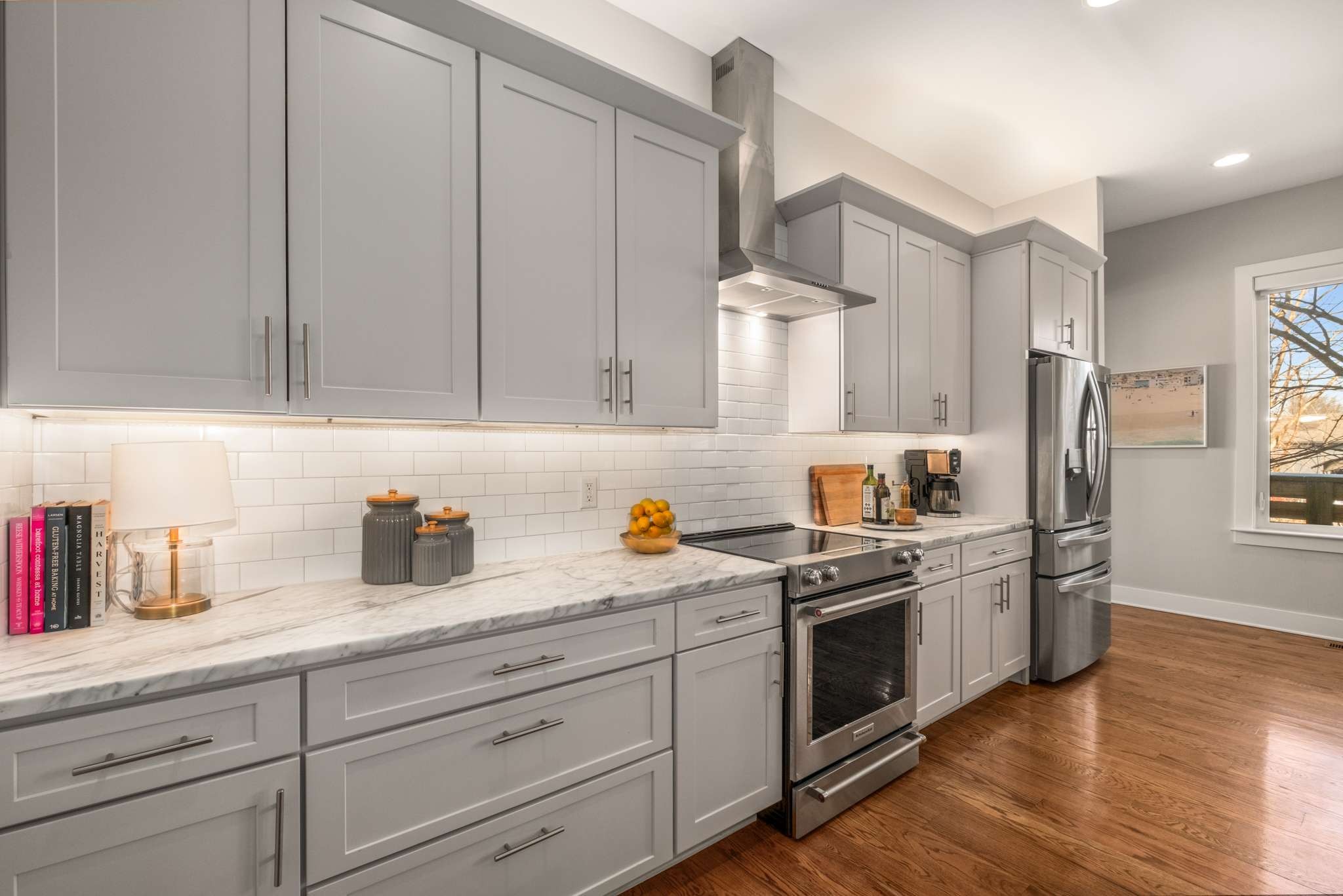115 Rains Avenue, Unit A Nashville, TN 37203 - Photo 12 of 46 a kitchen with stainless steel appliances granite countertop white cabinets and a refrigerator
