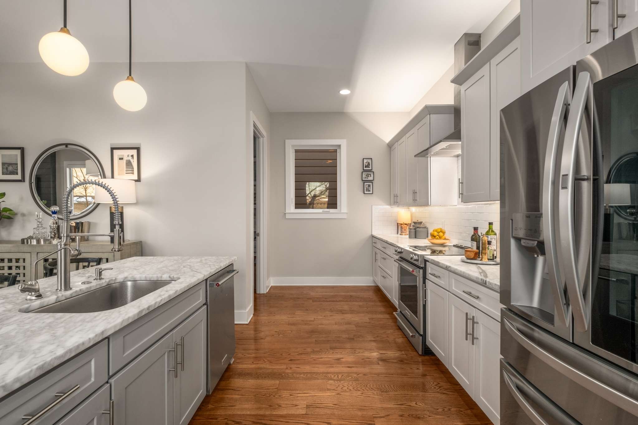115 Rains Avenue, Unit A Nashville, TN 37203 - Photo 13 of 46 a kitchen with kitchen island granite countertop a sink and refrigerator