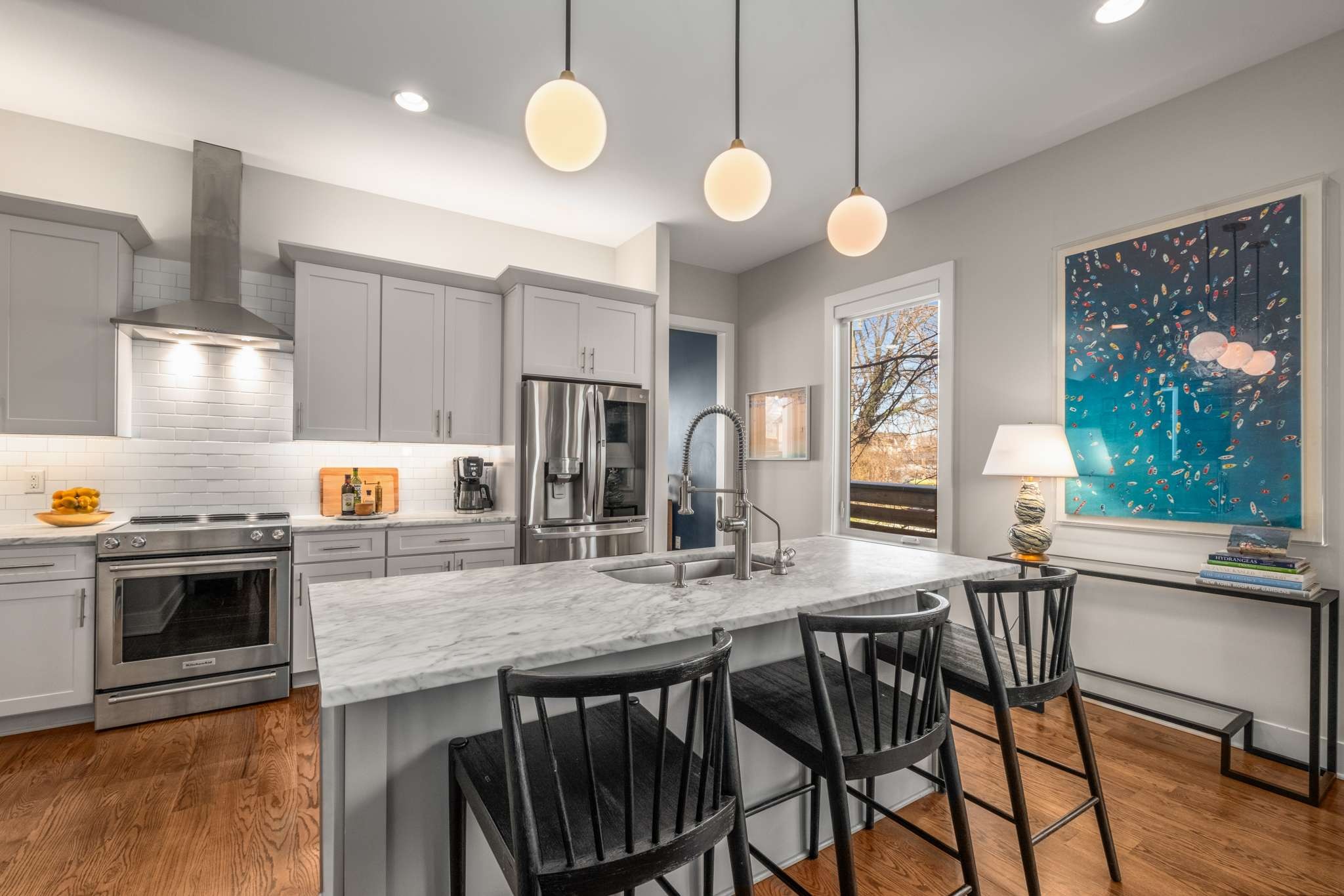 115 Rains Avenue, Unit A Nashville, TN 37203 - Photo 15 of 46 a kitchen with stainless steel appliances granite countertop a stove a sink and a refrigerator