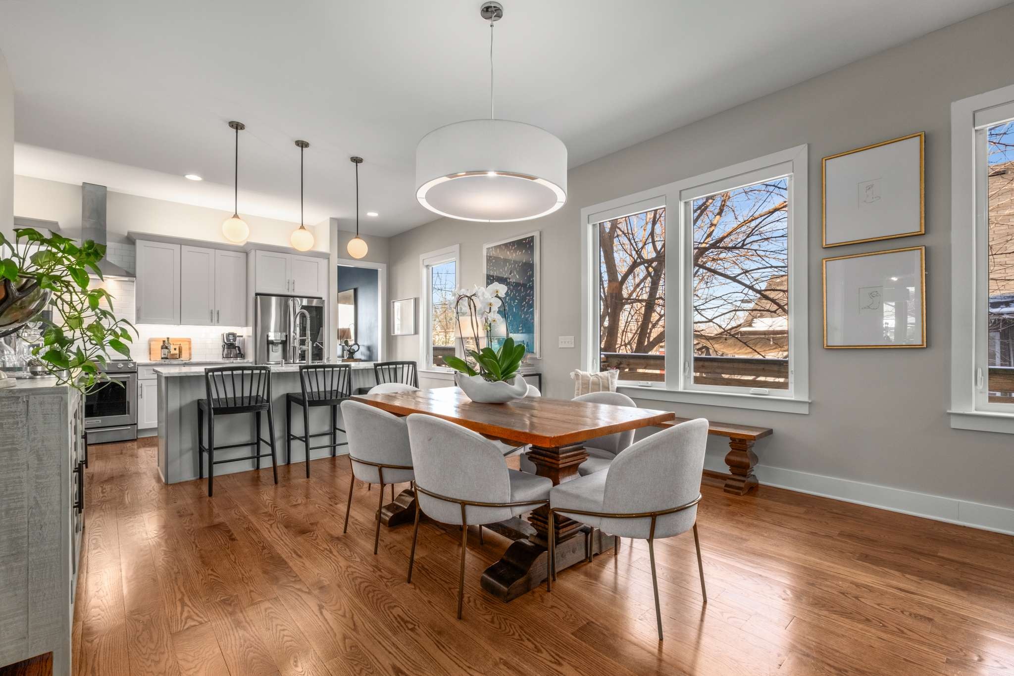 115 Rains Avenue, Unit A Nashville, TN 37203 - Photo 16 of 46 a dining room with wooden floor a chandelier a wooden table and chairs