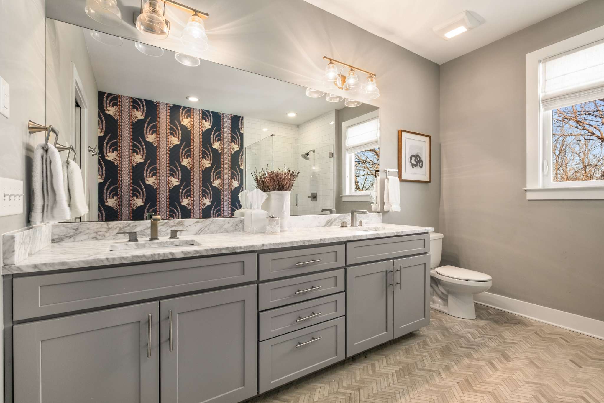 115 Rains Avenue, Unit A Nashville, TN 37203 - Photo 27 of 46 a bathroom with a granite countertop sink a toilet and a mirror