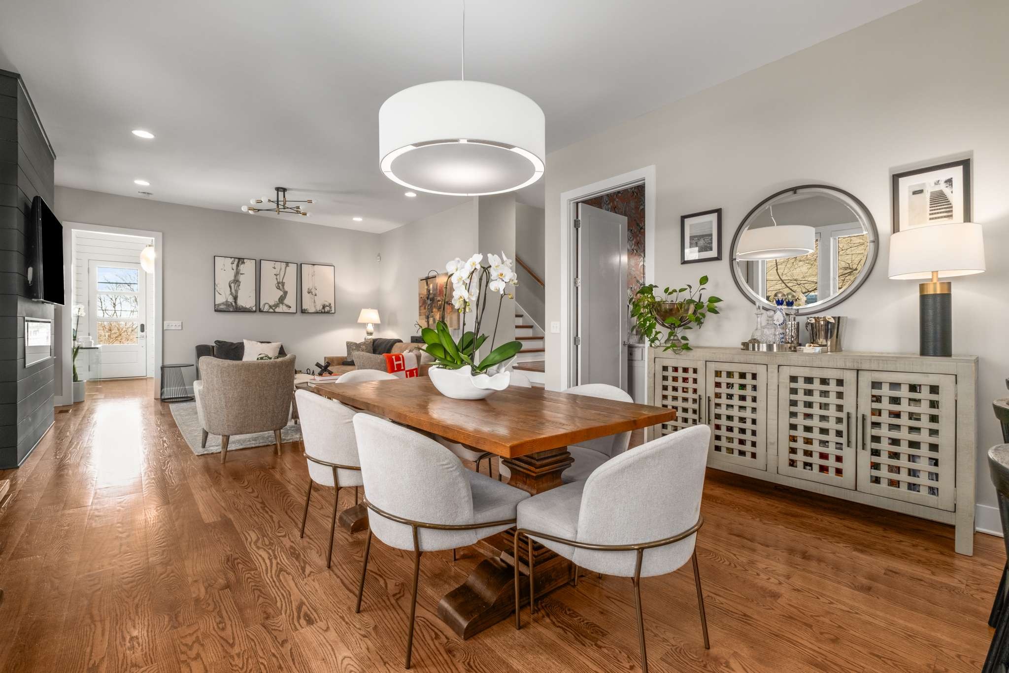 115 Rains Avenue, Unit A Nashville, TN 37203 - Photo 10 of 46 a view of a dining room with furniture a chandelier and wooden floor