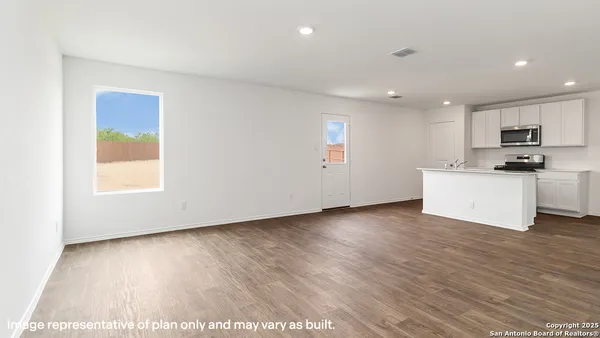 a view of a kitchen with a sink and a refrigerator